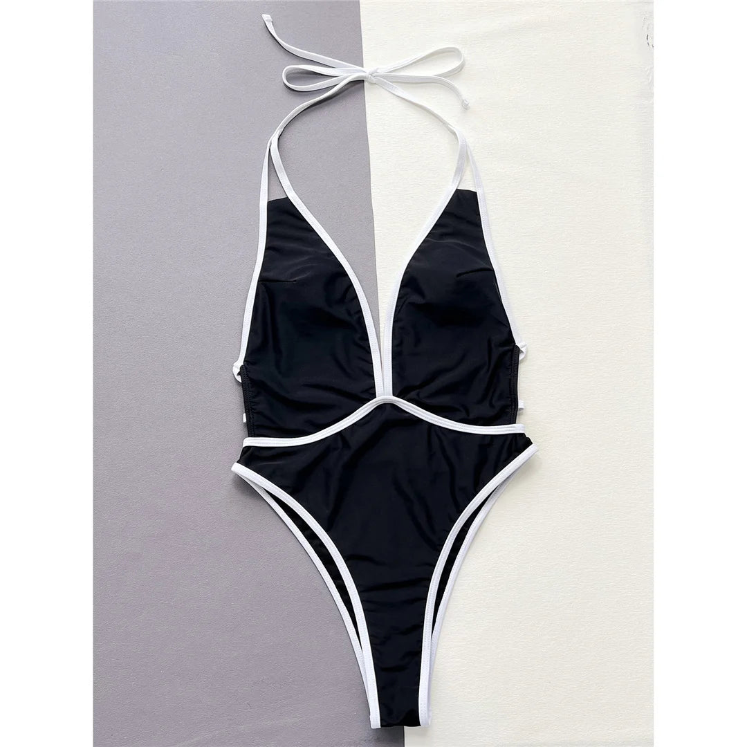 Black Deep V-Neck Halter One-Piece Swimsuit with High Cut and Backless Design. Monokini in Solid Nylon and Spandex, Fits True to Size. Available in Sizes S, M, and L. Free Support with Padded Design. Perfect for Women and Adults. The product is in Stock with Free Shipping included.