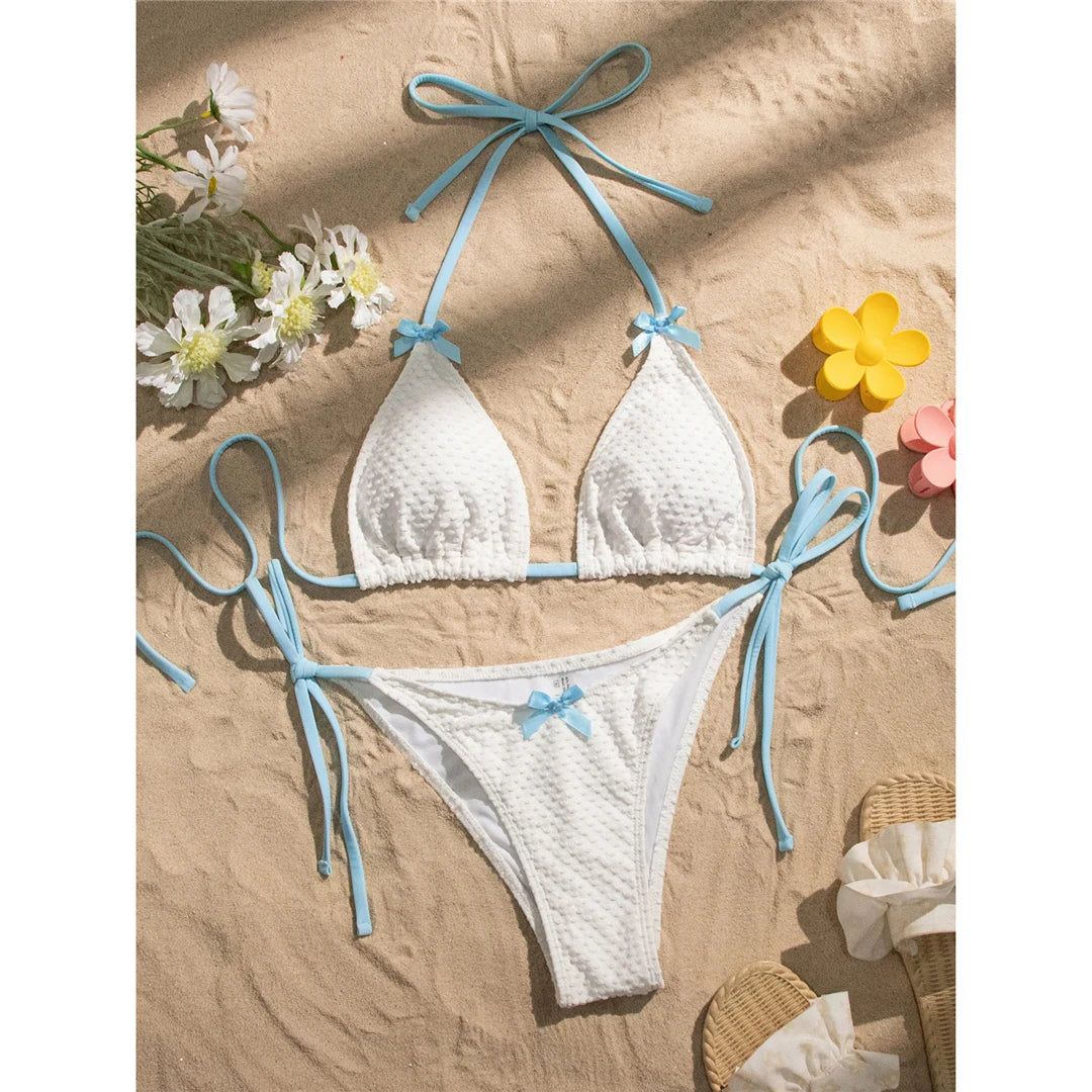 Halter high-leg cut bikini set with bow and strappy details for a playful and flattering swimwear option for women.