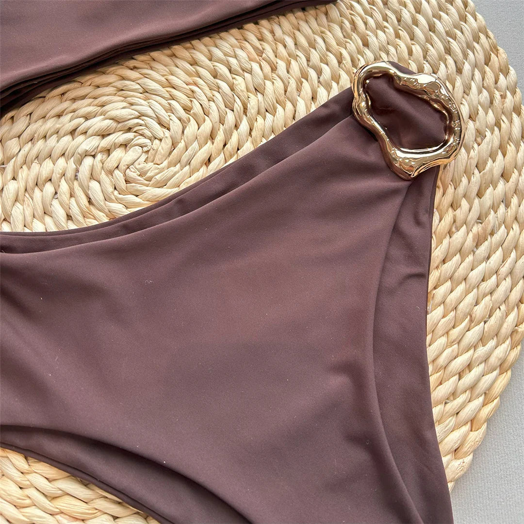 Asymmetric Metal Ring Swimsuit with stylish ring embellishments, monochrome solid color, polyester and spandex blend, adjustable shoulder straps, perfect for modern beach fashion.