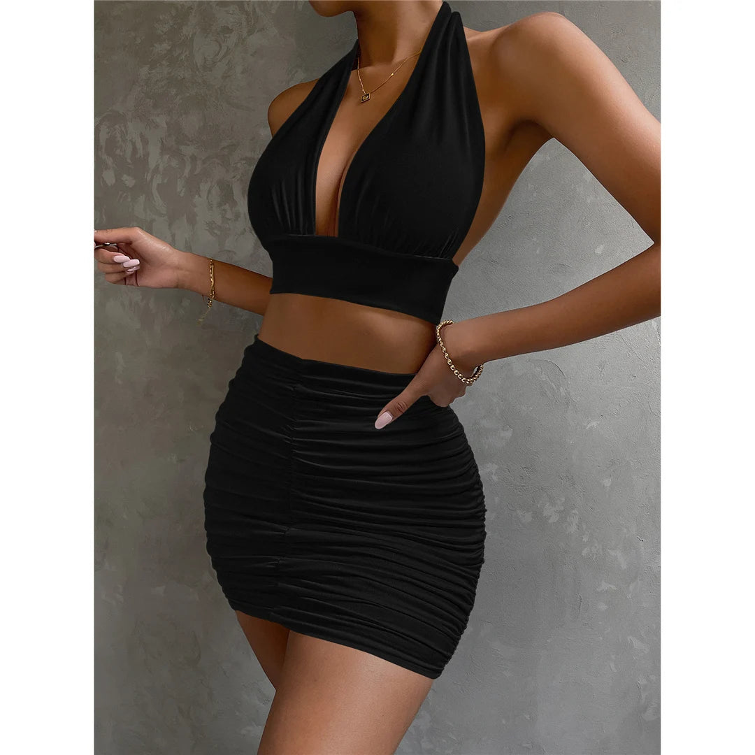 Chic ruffle mini dress set with a flattering bodycon fit, including a sleeveless V-neck top and pleated summer skirt in solid colors for women.