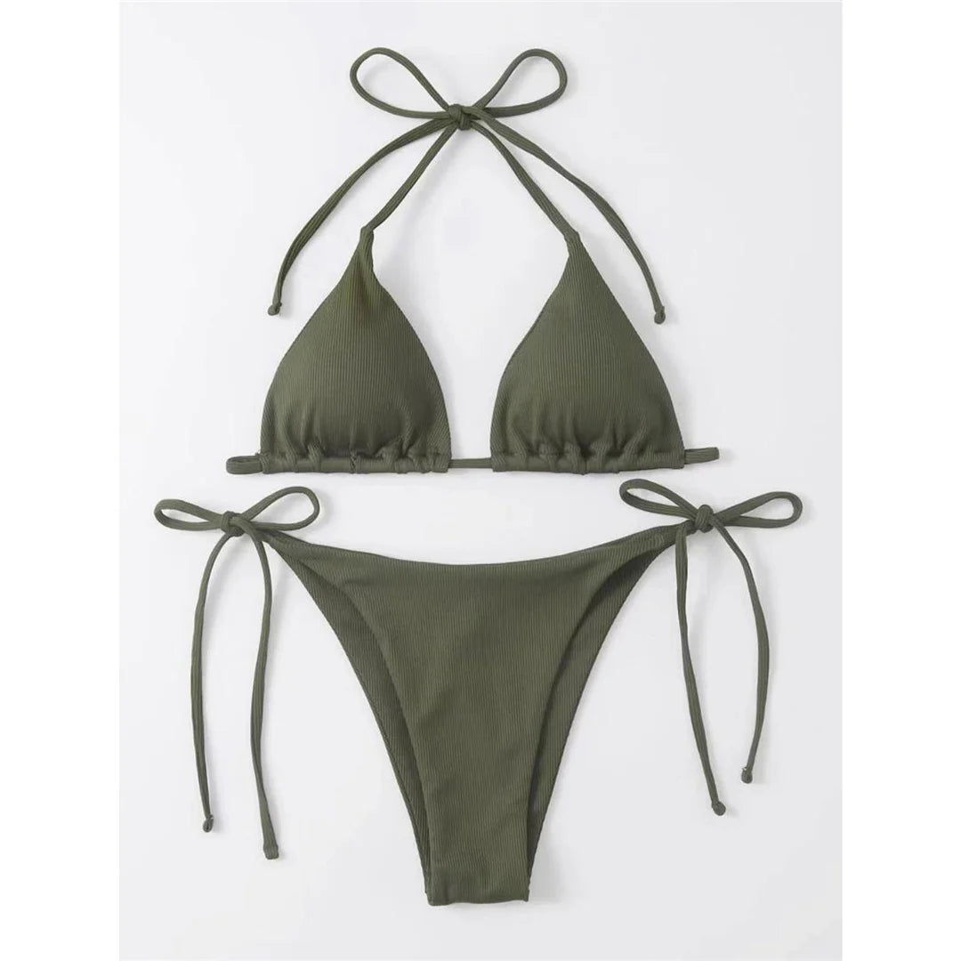 Bask in the sun with our Halter Ribbed Bikini Set, available in Black, Coffee, Army Green, Peach, Brick Red, White, and Light Green. This chic two-piece ensemble made from nylon and spandex features a textured ribbed fabric and a padded halter top. Fitting true to size, this low waist bikini set offers both support and style. Perfect for the modern woman who seeks a blend of contemporary design and classic bikini charm in her swimwear.