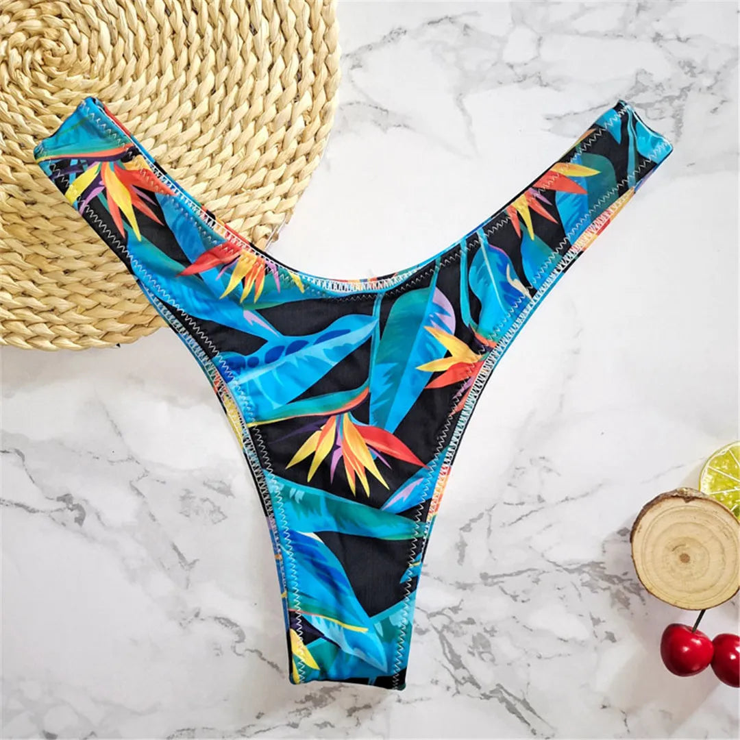 Stylish printed bikini bottoms in vibrant colors, Brazilian tanga cut swimwear for women made with nylon and spandex. Perfect for lounging by the beach or swimming, wire free support and low waist design with a true to size fit. Part of a bikinis set without pad, resonating beach style in leaves print. Female swimwear for ages 18 to 35 and adult, available in stock and comes with free shipping offer.
