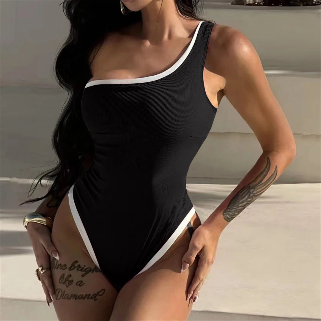 One-shoulder ribbed high-cut leg one-piece swimsuit with splicing design and padded support for women.