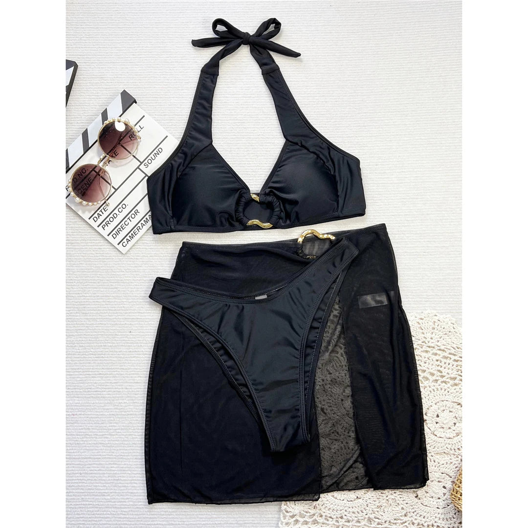 Chic halter bikini three-piece set with Brazilian cut and matching skirt in solid black, crafted from polyester and spandex.