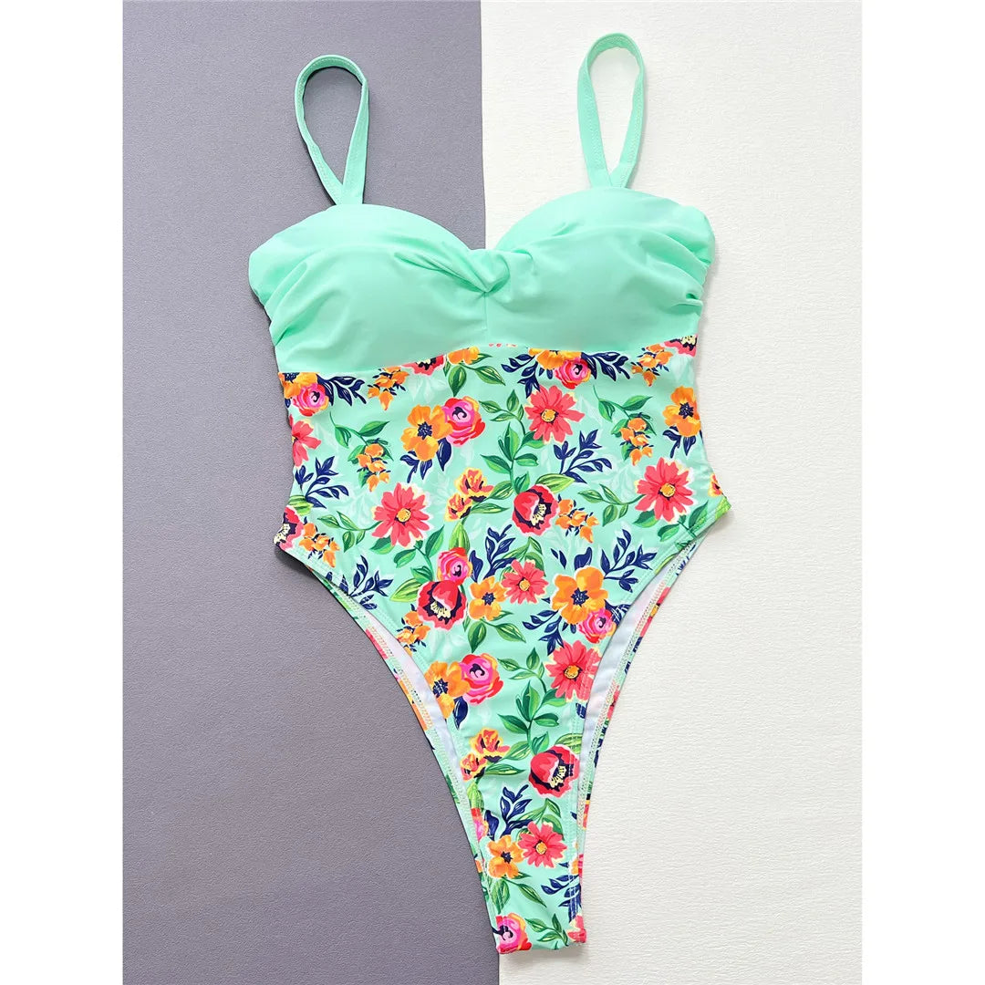 Elegant flowers printed splicing high leg cut one piece swimsuit in green. A visually striking monokini made from nylon and spandex, perfect for beach days or pool parties. Fits true to size, designed for women seeking grace, style, and swim confidence.