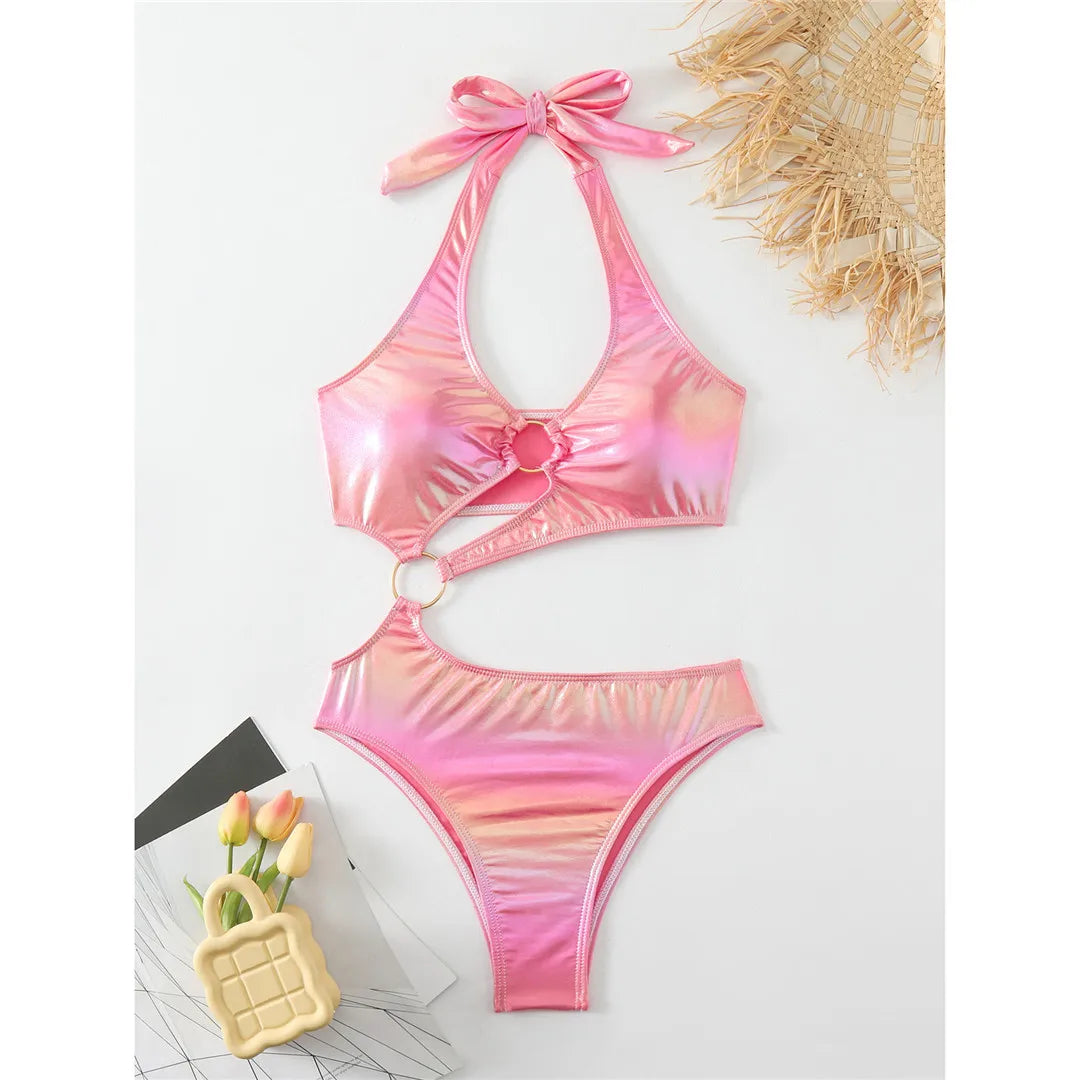Fashion-forward asymmetric PU faux leather halter one piece swimsuit in pink. Unique monokini design with a high leg cut, made from nylon and spandex. Fits true to size, perfect for contemporary and bold women.
