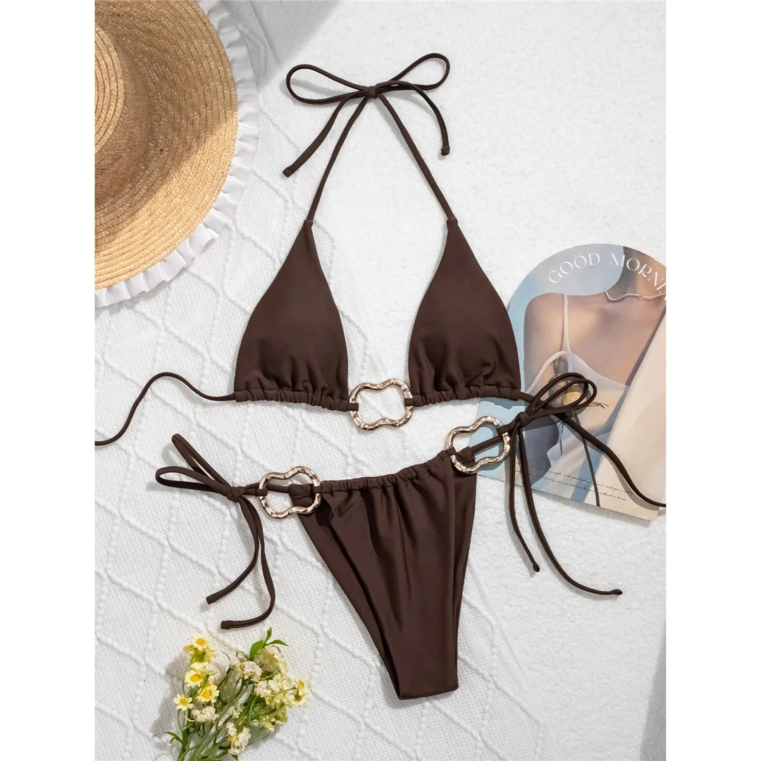 Halter high-leg cut bikini set with striking metal ring accents for a sleek and modern beach look for women.