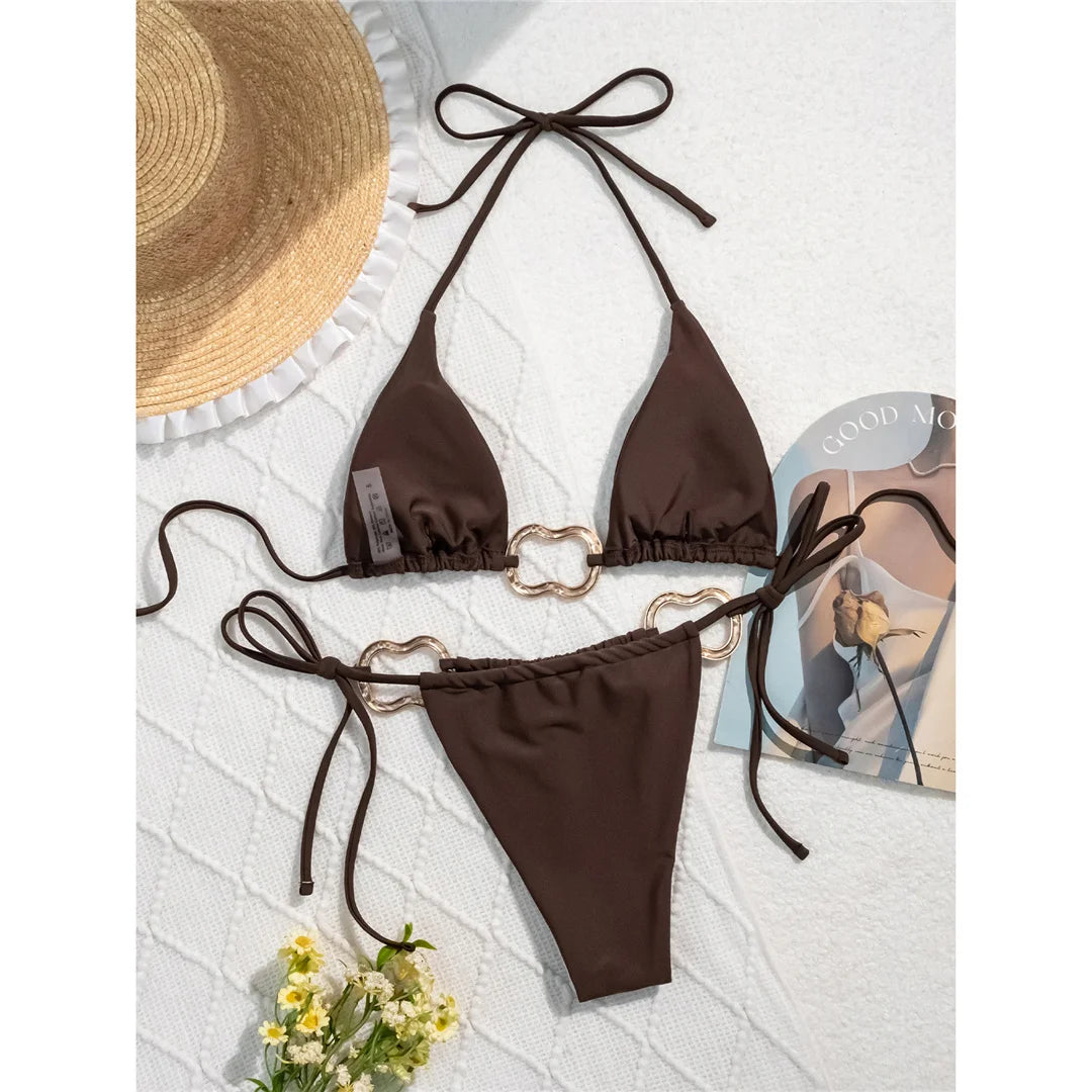 Halter high-leg cut bikini set with striking metal ring accents for a sleek and modern beach look for women.