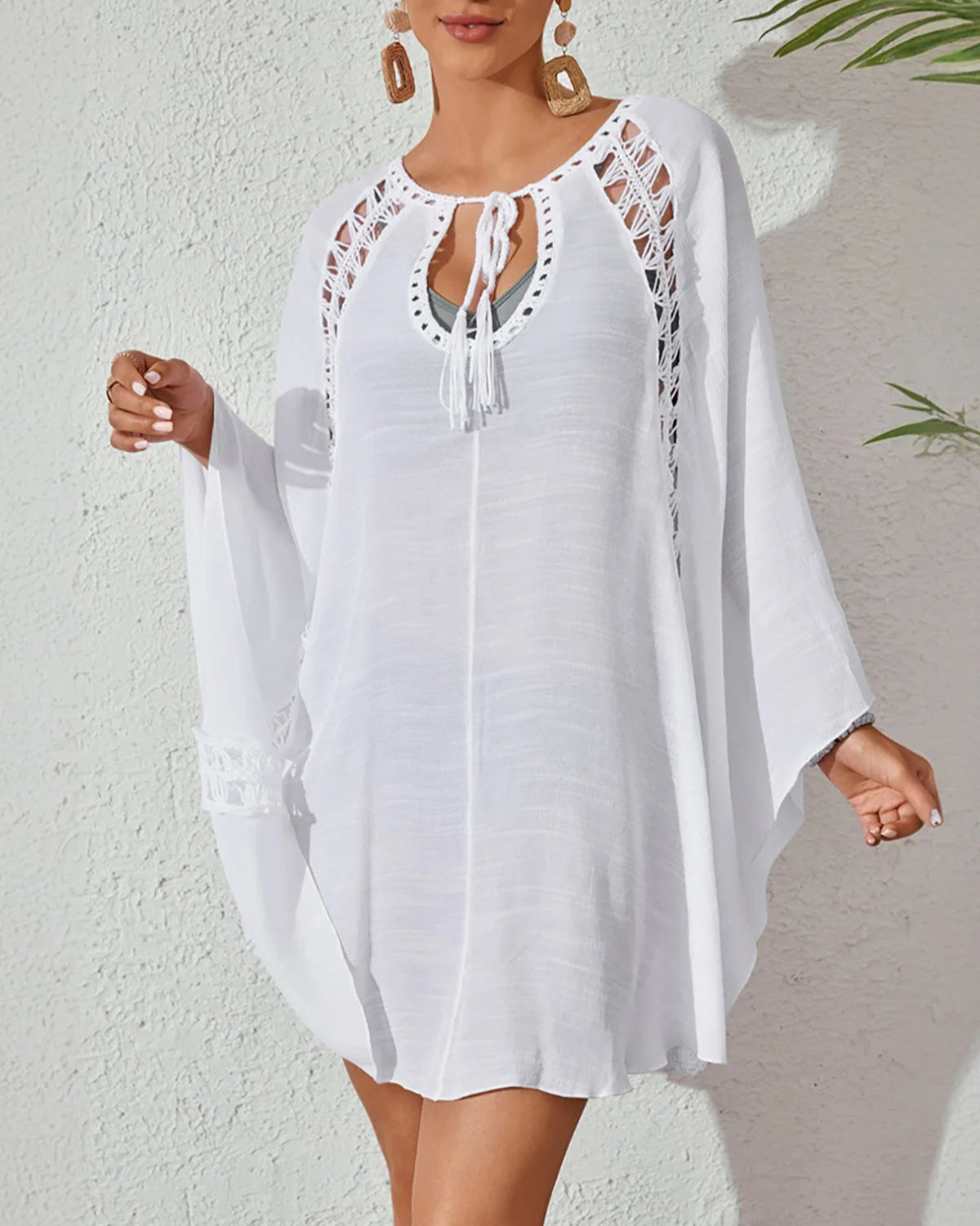 White long sleeve cut-out crochet knitted tunic beach cover-up with elegant design for women.