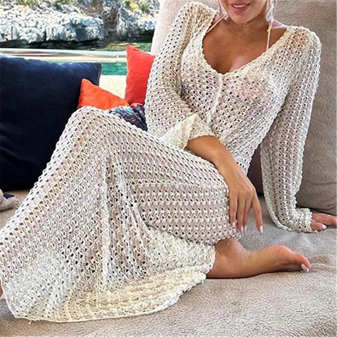 Elegant long sleeve crochet tunic beach cover-up, ideal for seaside styling. Features a delicate see-through design, crafted from a mix of nylon, polyester, rayon, and cotton. True to size, available in white.