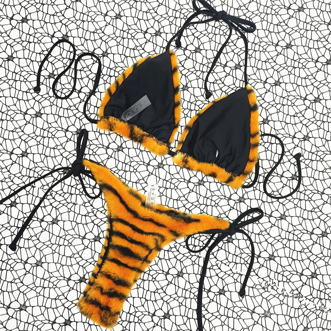 Unleash your wild side with a zebra print halter high cut strappy bikini set, featuring a bold animal pattern and high cut design. This striking two-piece swimsuit is complemented by stylish strappy details for a secure fit. Made from polyester and spandex, this wire-free, low waist bikini includes supportive pads, perfect for making a statement on sunny beach days.