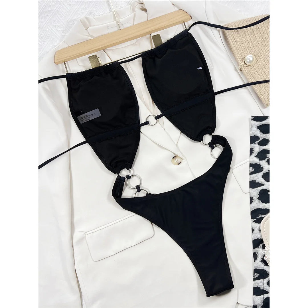 Metal Rings Halter Cut Out One Piece Swimsuit, Backless High Cut Monokini, Made of Nylon and Spandex, Solid Pattern, Wire-Free Support, True to Size, Women&#39;s Swimwear, Available in Sizes Small, Medium, Large, In Black Color, Free Shipping.