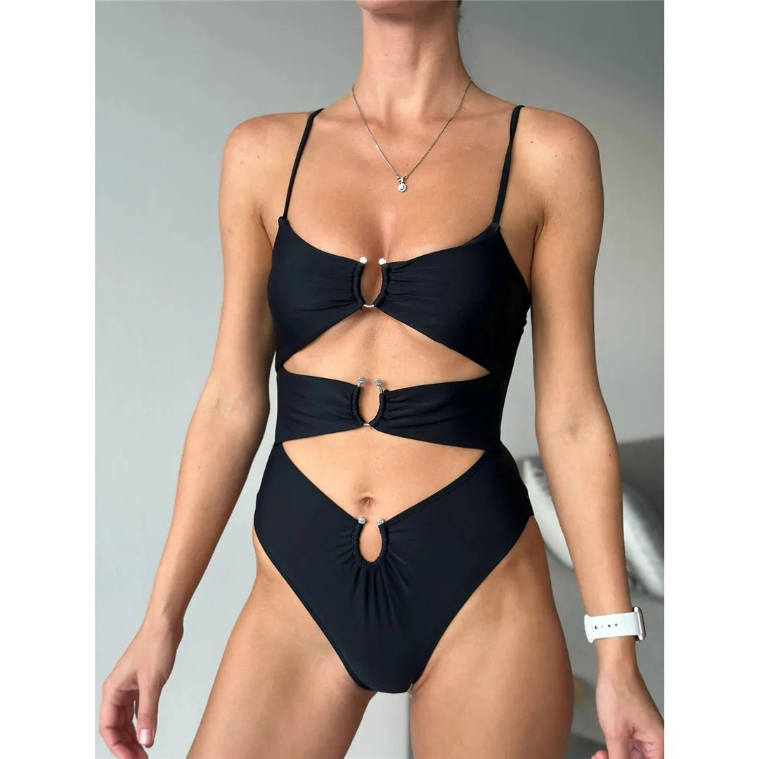 Turn heads in our Tummy Cut Out Metal Rings One Piece Swimsuit available in Black and White. This striking monokini, made from nylon and spandex, is designed with bold metal ring details and a high leg cut to accentuate your curves. Fitting true to size, this sleek solid color swimsuit with wire free and padded support is sure to be a showstopper at any beach or poolside event.