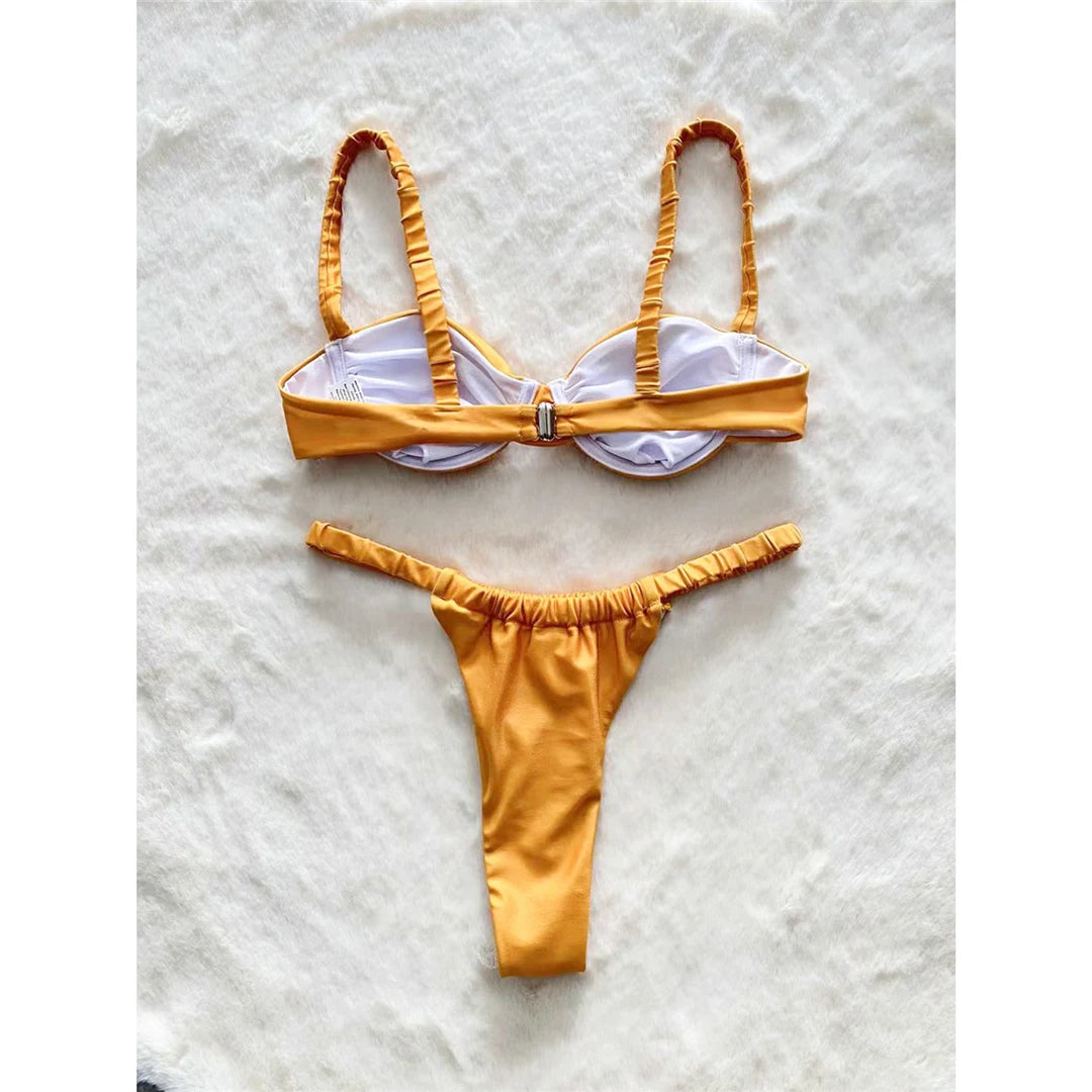 Chic wrinkled underwired mini micro thong bikini in solid gold, offering a low waist design and added support, crafted from nylon and spandex, perfect for stylish and comfortable beach outings for women