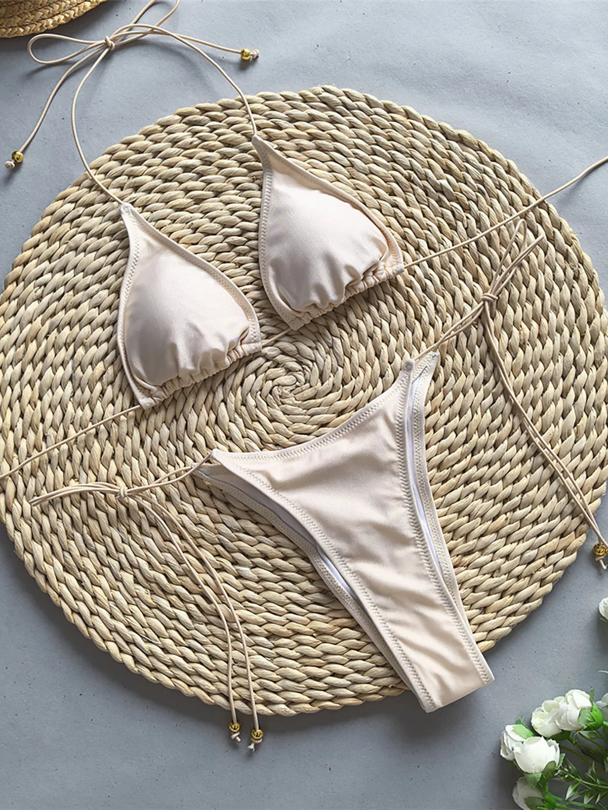 Halter scrunch butt bikini set with stylish skirt, three-piece ensemble, polyester spandex blend, wire-free support, low waist, women's solid swimwear, playful and versatile look.