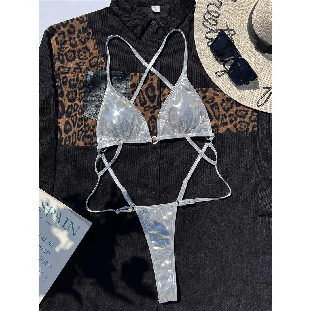 Faux Leather Extreme String Micro Thong One Piece Swimsuit for women in silver color. This edgy one-piece swimsuit made from PU, nylon, and spandex sports a micro thong cut and fits true to size, available in sizes S, M, L. Ideal for adults aged 18-35. This fashionable beachwear piece is in stock and offers free shipping.