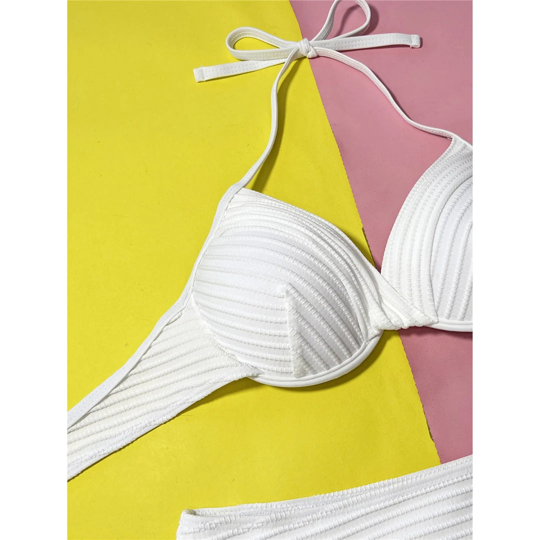 Beautifully Crafted Two-Piece Halter Bikini Set for Women, Features Underwire Support and a Unique Wrinkled Texture, Comes with a Mid-Waist Cut Bottoms for Comfort, Made from Nylon and Spandex in Solid White, Fits True to Size, Ideal for Basking in the Sun or Taking a Dip with Confidence and Style.