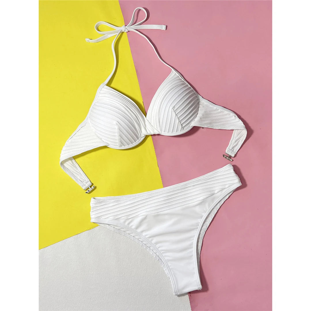 Beautifully Crafted Two-Piece Halter Bikini Set for Women, Features Underwire Support and a Unique Wrinkled Texture, Comes with a Mid-Waist Cut Bottoms for Comfort, Made from Nylon and Spandex in Solid White, Fits True to Size, Ideal for Basking in the Sun or Taking a Dip with Confidence and Style.